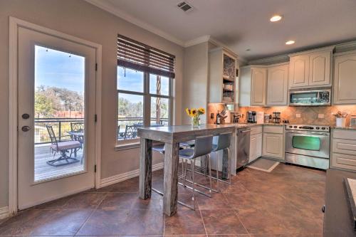 a kitchen with a table and a large window at Lake LBJ Waterfront Vacation Rental! in Granite Shoals