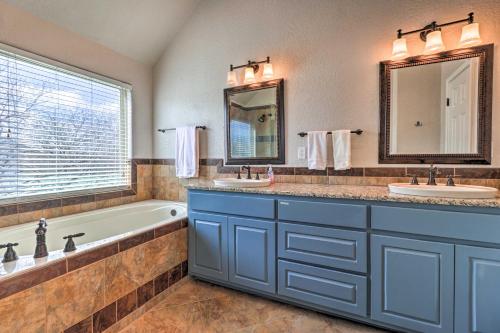 a bathroom with two sinks and a bath tub at Lake LBJ Waterfront Vacation Rental! in Granite Shoals