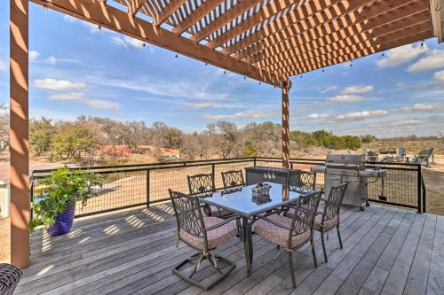 a patio with a table and chairs on a deck at Lake LBJ Waterfront Vacation Rental! in Granite Shoals