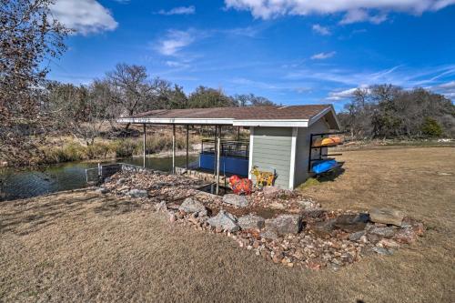 a small shed with a rock garden in front of a river at Lake LBJ Waterfront Vacation Rental! in Granite Shoals