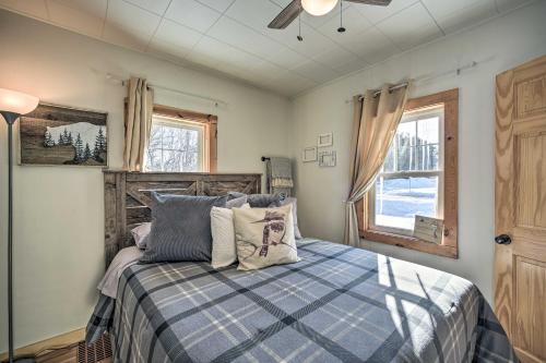 a bedroom with a bed and a window and a ceiling fan at Family Home - Walk to Town and Balsam Lake! in Balsam Lake
