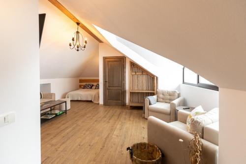 a living room with a couch and a bed at Casa Sena in Moieciu de Sus