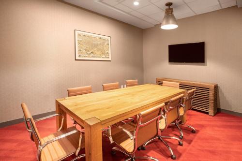 a conference room with a wooden table and chairs at Hotel Indigo Denver Downtown - Union Station by IHG in Denver