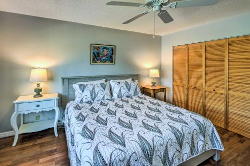 a bedroom with a bed and a nightstand and two lamps at Sunny St Augustine Condo with Community Pool! in Saint Augustine
