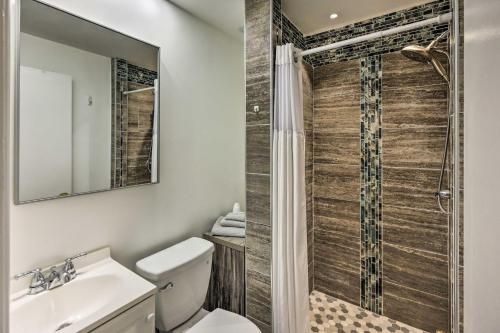 a bathroom with a shower and a toilet and a sink at Sunny St Augustine Condo with Community Pool! in St. Augustine