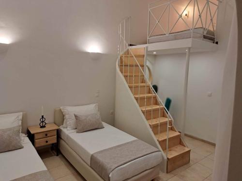 a bedroom with a bunk bed and a staircase at Amerisa Suites & Villa in Fira