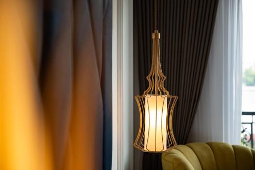 a chandelier hanging from a wall next to a window at Soleil Boutique Hotel Hanoi in Hanoi
