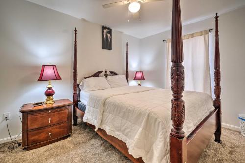 a bedroom with a four poster bed and two lamps at Maryland Vacation Home Near US Capital! in Riverdale Park