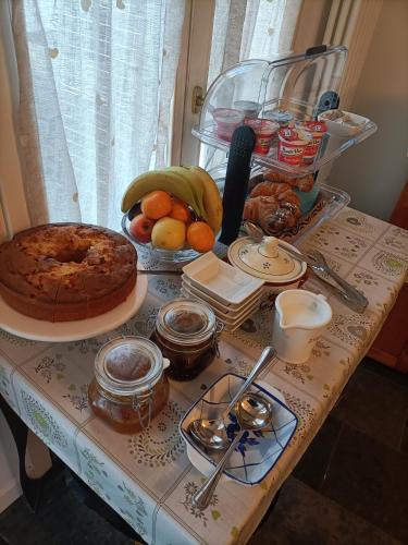 a table with a cake and other food on it at Atmosfera Affittacamere in Ravenna