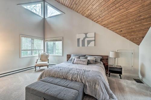 een slaapkamer met een bed, een stoel en ramen bij Mountaintop Wintergreen Resort House with Deck in Roseland