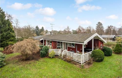 a red and white house with a yard at Lovely Home In Hornbæk With Sauna in Hornbæk