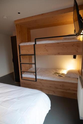a couple of bunk beds in a room at L'Orée des Sources in Volvic