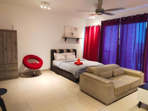 - une chambre avec un lit et une chaise rouge dans l'établissement Trefoil, à Setia Alam