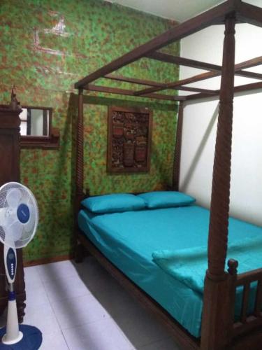 a bedroom with a bed with a fan in it at 8 Up House in Betek
