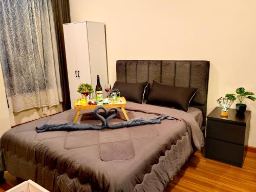 a bedroom with a bed with a table on it at Petalz Luxury Suite 10Pax MID VALLEY OLD KLANG ROAD OUG KLANG LAMA KL in Kuala Lumpur