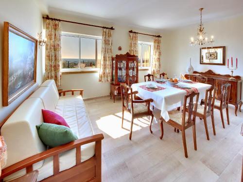 a living room with a white table and a couch at Inn The Beach Apartments by Seareen in Albufeira