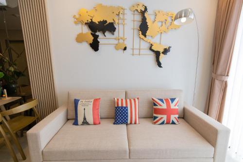 a couch with pillows and a map of the world at The Song Luxury Condotel Vung Tau - Căn hộ cao cấp Luca's House in Vung Tau