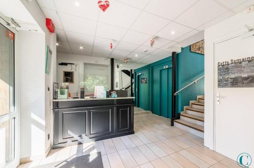 a hallway with a counter and stairs in a building at Hotel Restaurant au Floridor in Thann