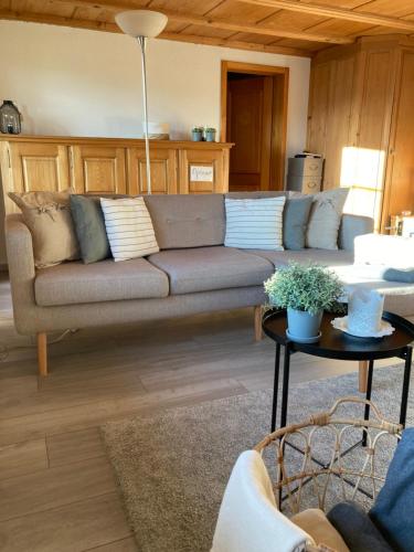 sala de estar con sofá y mesa en Appartement mit Alpensicht, beheiztem Pool, Garten, 