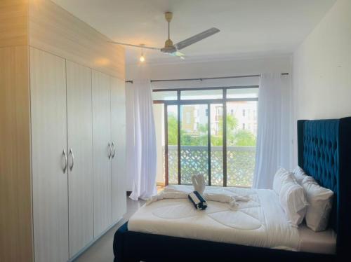 - une chambre avec un lit et une grande fenêtre dans l'établissement Lux Suites 2 Bedroom Sultan Palace Apartments, à Kikambala