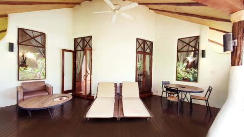 a living room with a couch and a table at Koh Tao Cabana in Koh Tao