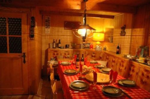 a kitchen with a table with plates on it at Baita Giggia sulle piste - Cavalese in Trentino Alto Adige cottage chalet in Cavalese