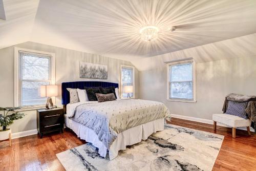a bedroom with a large bed with a blue headboard at Luxurious Detroit Home - Walk to Golf and Park! in Detroit