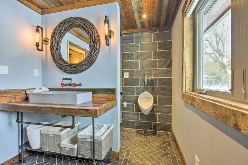 a bathroom with a sink and a mirror at Hayward Cabin on Lac Courte Oreilles! in Hayward