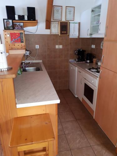 a small kitchen with a sink and a stove at Tourist Farm Znidarjevi in Kožljek