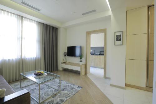 a living room with a couch and a table at Seine Apartment by Downtown Inn, City Center in Yerevan