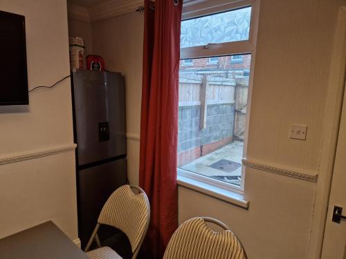 a kitchen with a window and a table and chairs at Grange Villa Amethyst 3 Bed House near Chester le Street, sleeps 6 Guests in Chester-le-Street