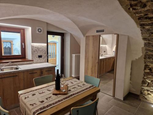 a kitchen with a table and a sink at da Annette rifugio montano in Villaretto