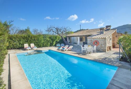 a swimming pool in front of a house at Owl Booking Villa Can Gorreta - 5 Min Walk To The Old Town in Pollença