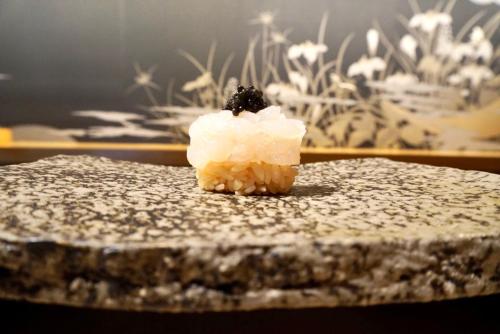 a piece of cake with a blackberry on top of it at THE skM TOKYO HOTEL & DINING in Tokyo
