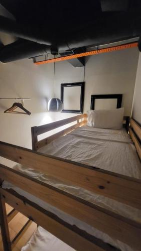 a large wooden bed in a room with at Kim Haus Loft in George Town