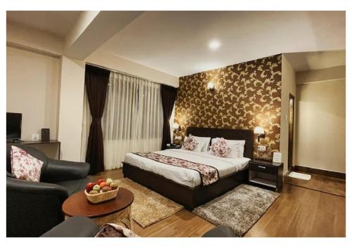 a hotel room with a bed and a couch at Stay villa Retreat in Pelling