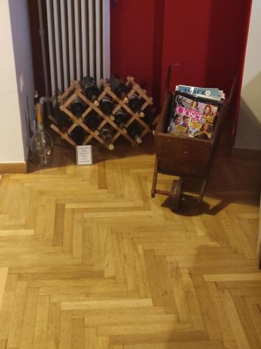 a room with a wooden floor and a cart with wine bottles at ATHENS RIVIERA SEA VIEW APARTMENT in Piraeus