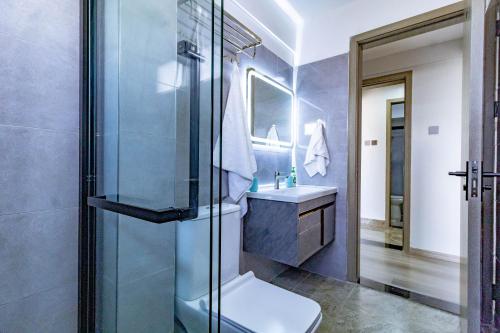 a bathroom with a shower and a toilet and a sink at Lovely 2 bedroom Condo with stunning city views in Nairobi