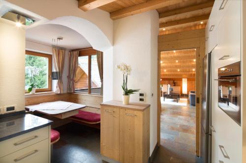 a kitchen with a table and a counter top at Residence Mugun in Corvara in Badia
