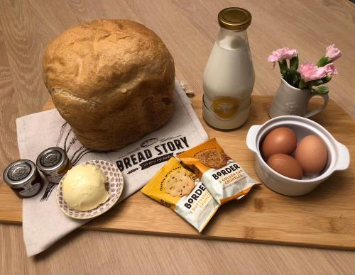 a loaf of bread sitting on a table with eggs and cheese at Highland cabin - relaxing hot tub in Inverness