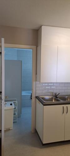 a kitchen with a sink and a counter top at Large beachstudio seaview Blankenberge near Brugge in Blankenberge