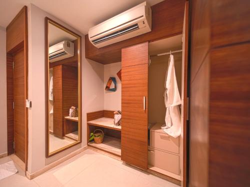 a walk in closet with a door and a mirror at Estrela Do Mar Beach Resort - A Beach Property in Calangute