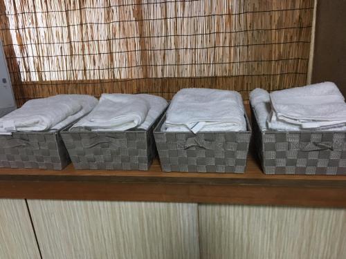 three mattresses sitting on a shelf in a room at ゲストハウスさくら Guesthouse Sakura in Sukumo