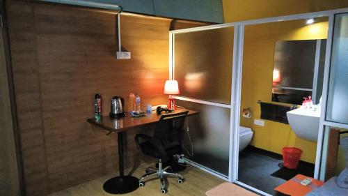 a bathroom with a desk and a sink and a toilet at Palms Villa in Negombo
