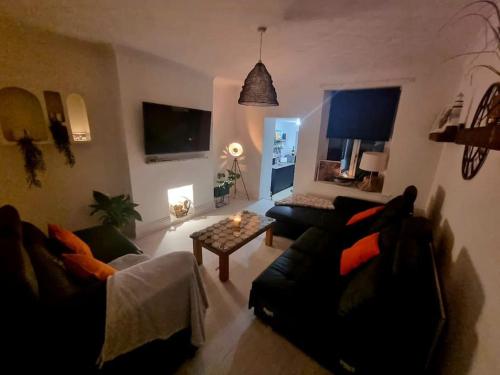 a living room with two couches and a table at The Light House in Seaham