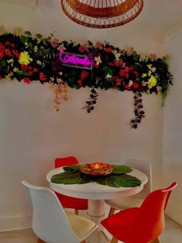 a dining room with a table and chairs and flowers at The Light House in Seaham