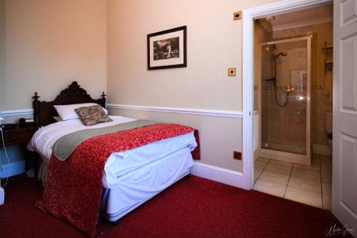a bedroom with a bed and a walk in shower at Old Rectory in Wem
