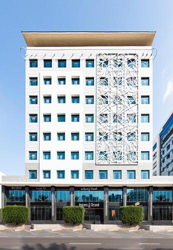 a large white building with a ferris wheel on it at Asiana Grand Hotel in Dubai