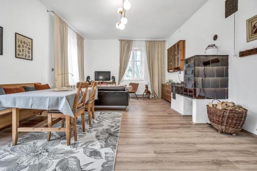 a kitchen and living room with a table and chairs at Romantická Chalupa Louka in Louka