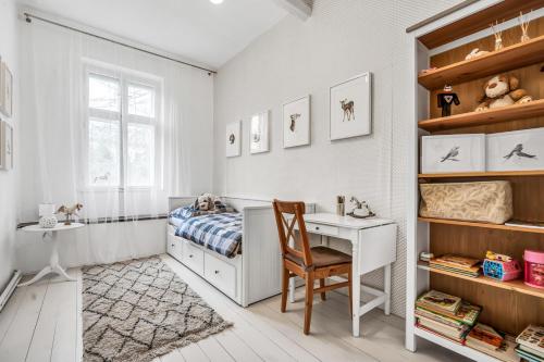 a bedroom with a desk and a bed and a chair at Romantická Chalupa Louka in Louka